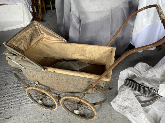 Picture of an old, battered pram.